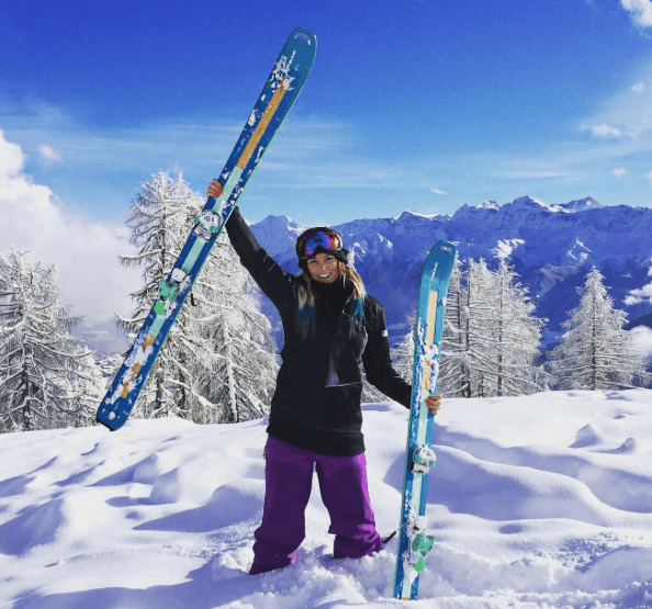 British Ski-cross Pro, Pam Thorburn skies above her head in the back country