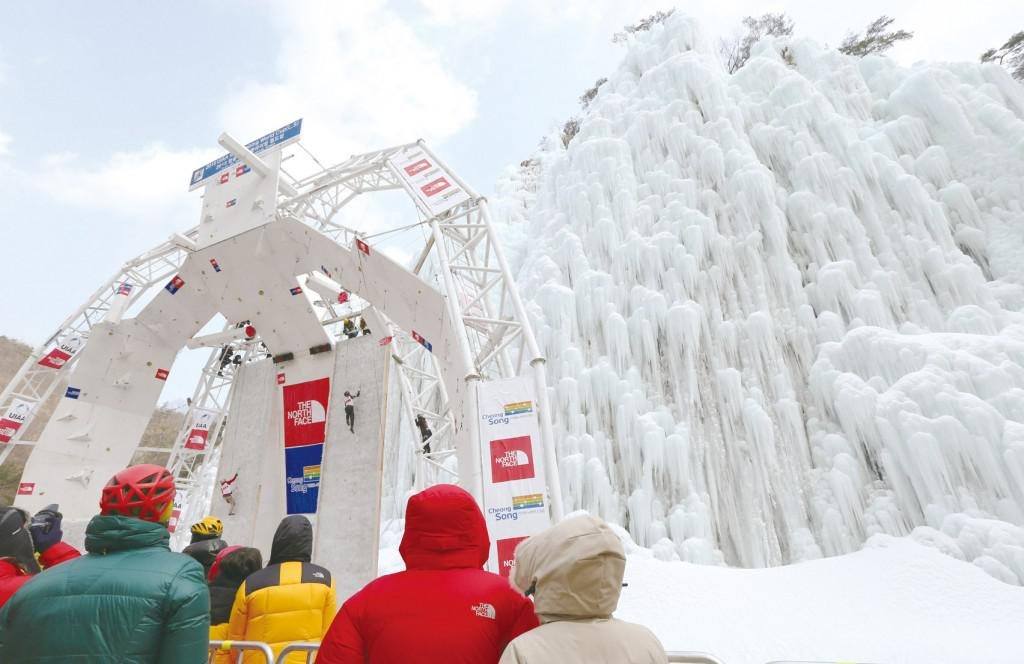 Fans look on as climbers speed climb to the top of an ice wall at the World Cup Ice Climbing event in Cheongsong, South Korea. Photo Credit: Seoul Selection