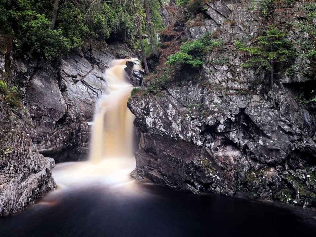 Stunning waterfall at Bruar Falls in Perthshire, one of the top places to go canyoning in Scotland 