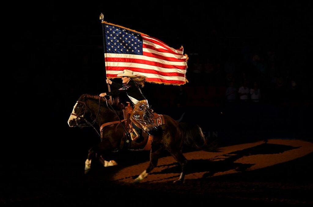 Rodeo Austin flag carrier on a horse