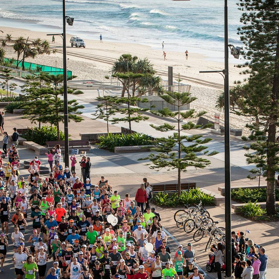 gold coast marathon runners by the beach