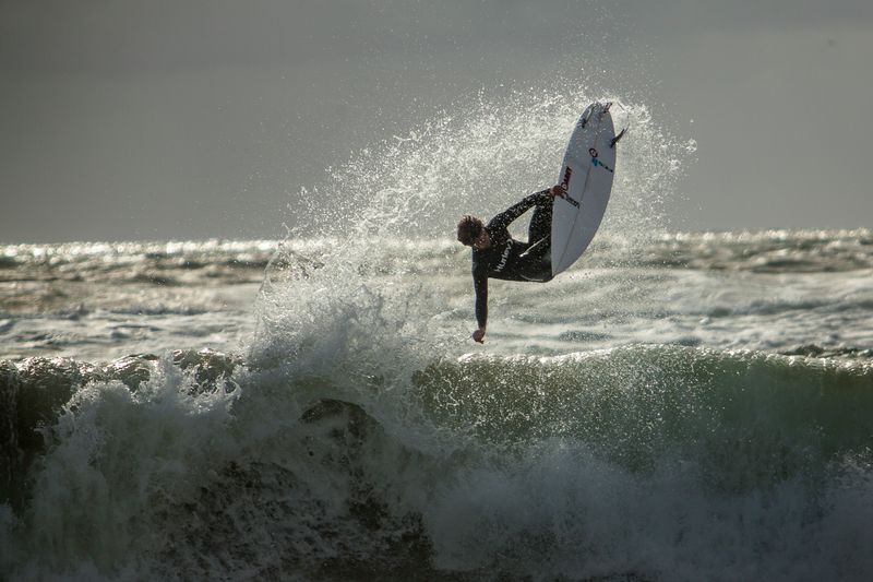 Surfing Ireland surfer does an air and grab in Bundoran